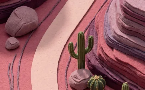 Dusk: a canyon of layered felt with a cactus.